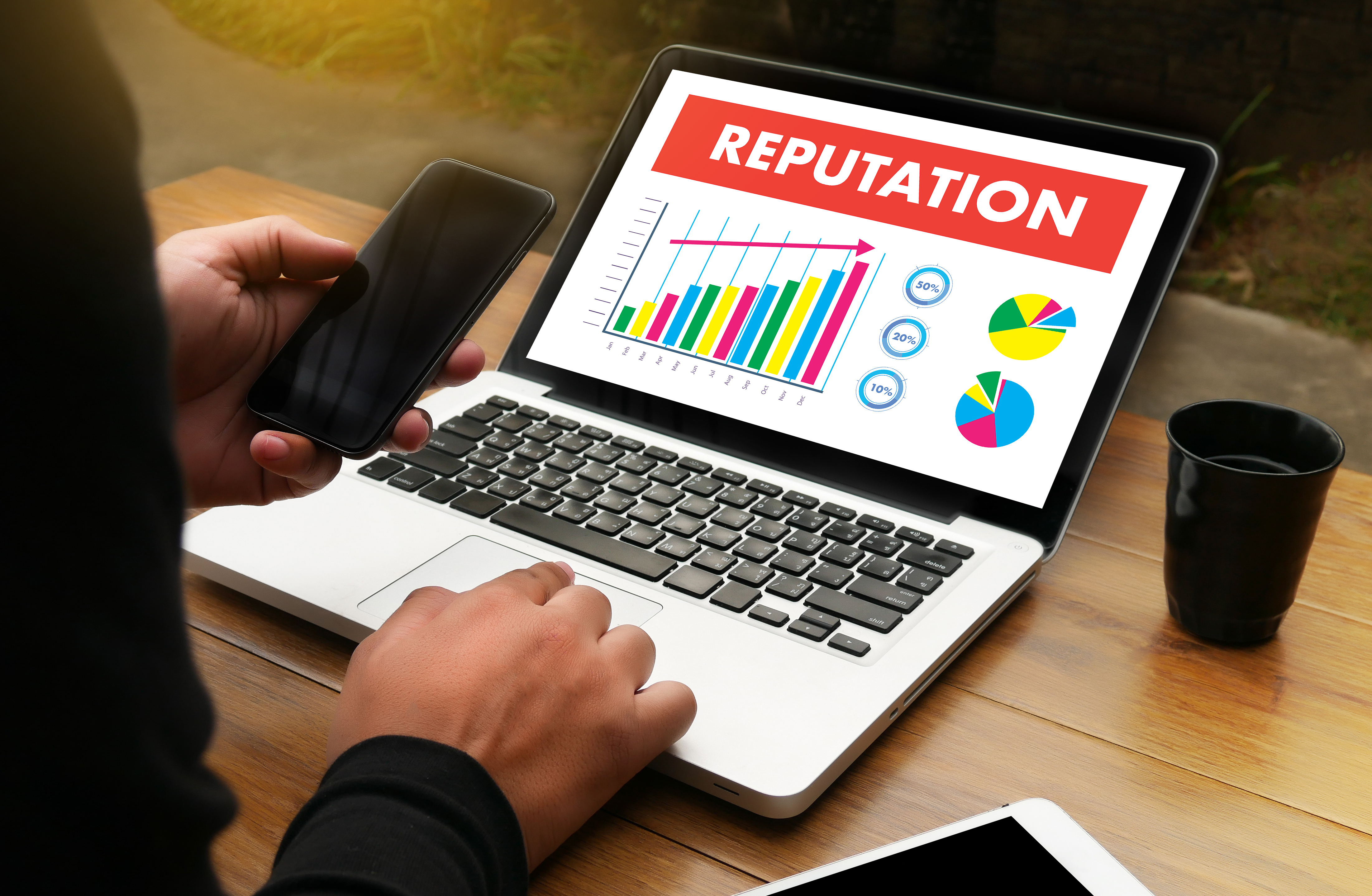 Person checking cell phone for online precence & reputation
